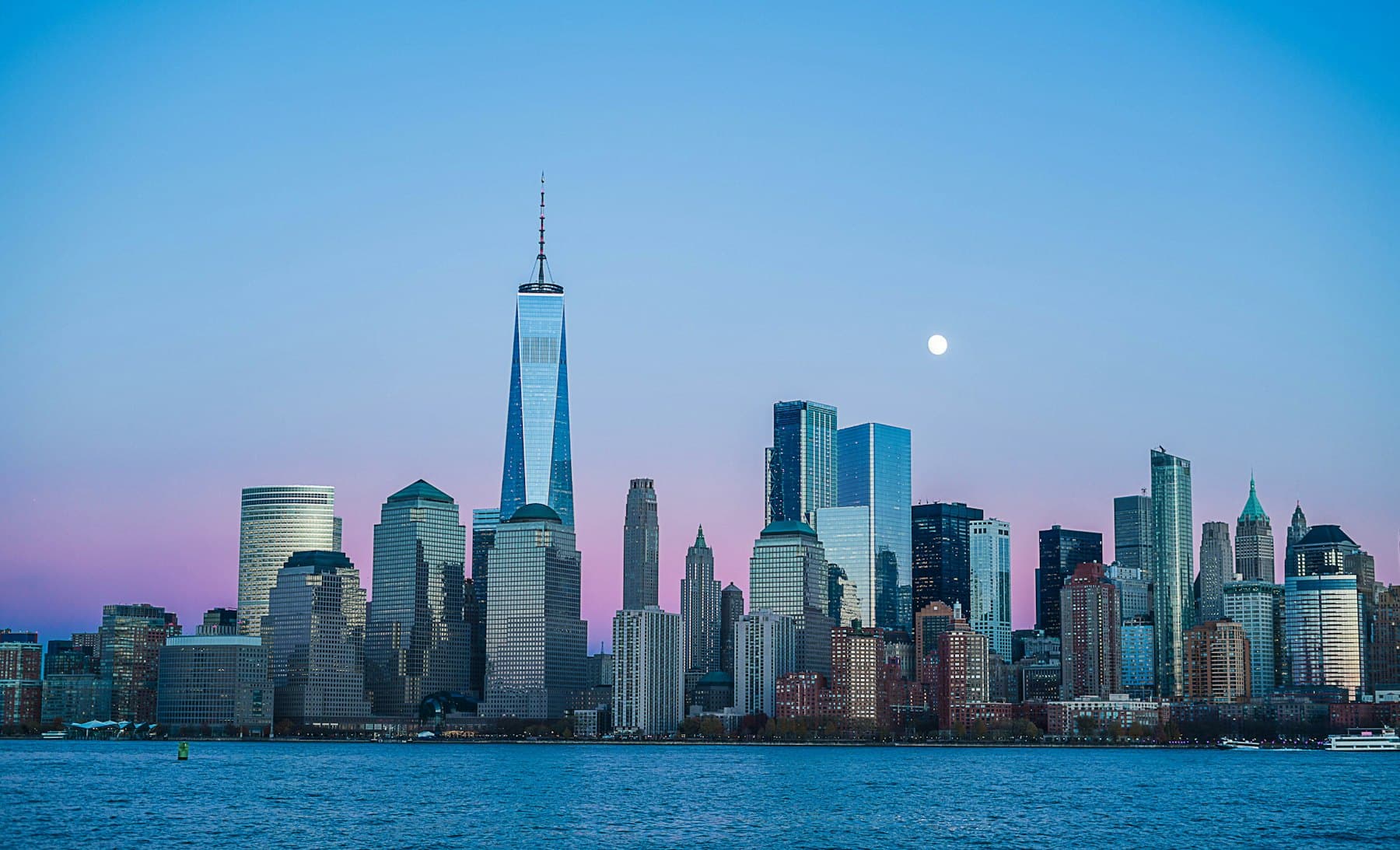 City skyline at twilight as the lights come on