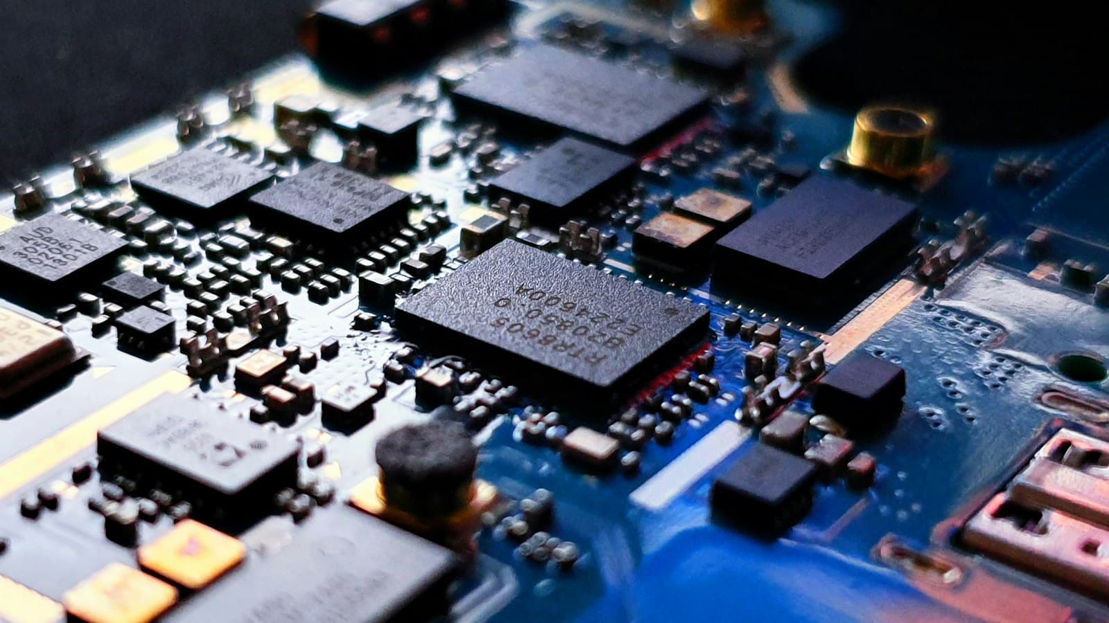 Close-up of precisely placed components on a blue circuit board
