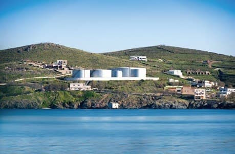 Island coastline with buildings and a water tank